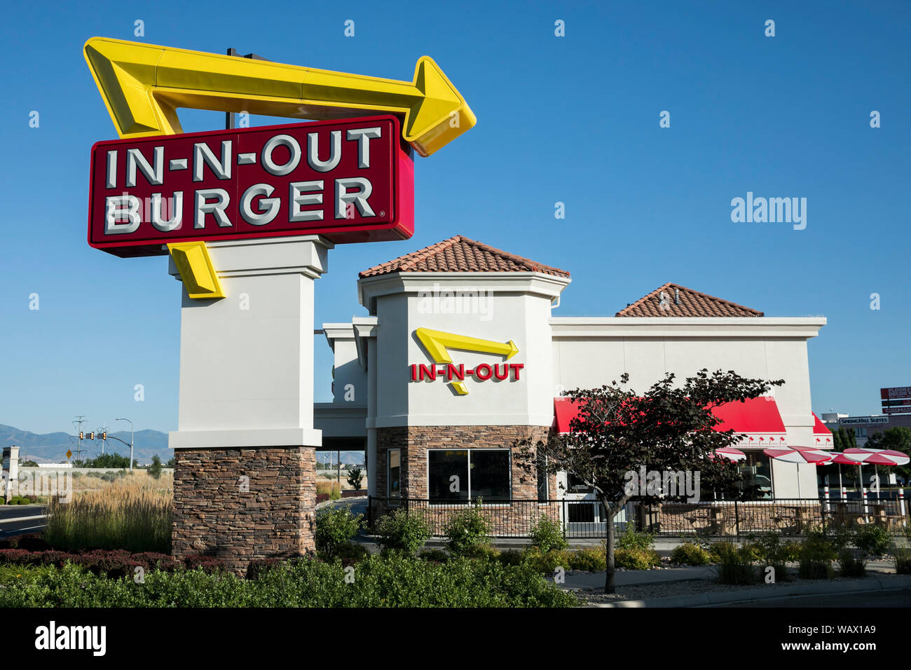 A logo sign outside  of a In N Out Burger fast  food  