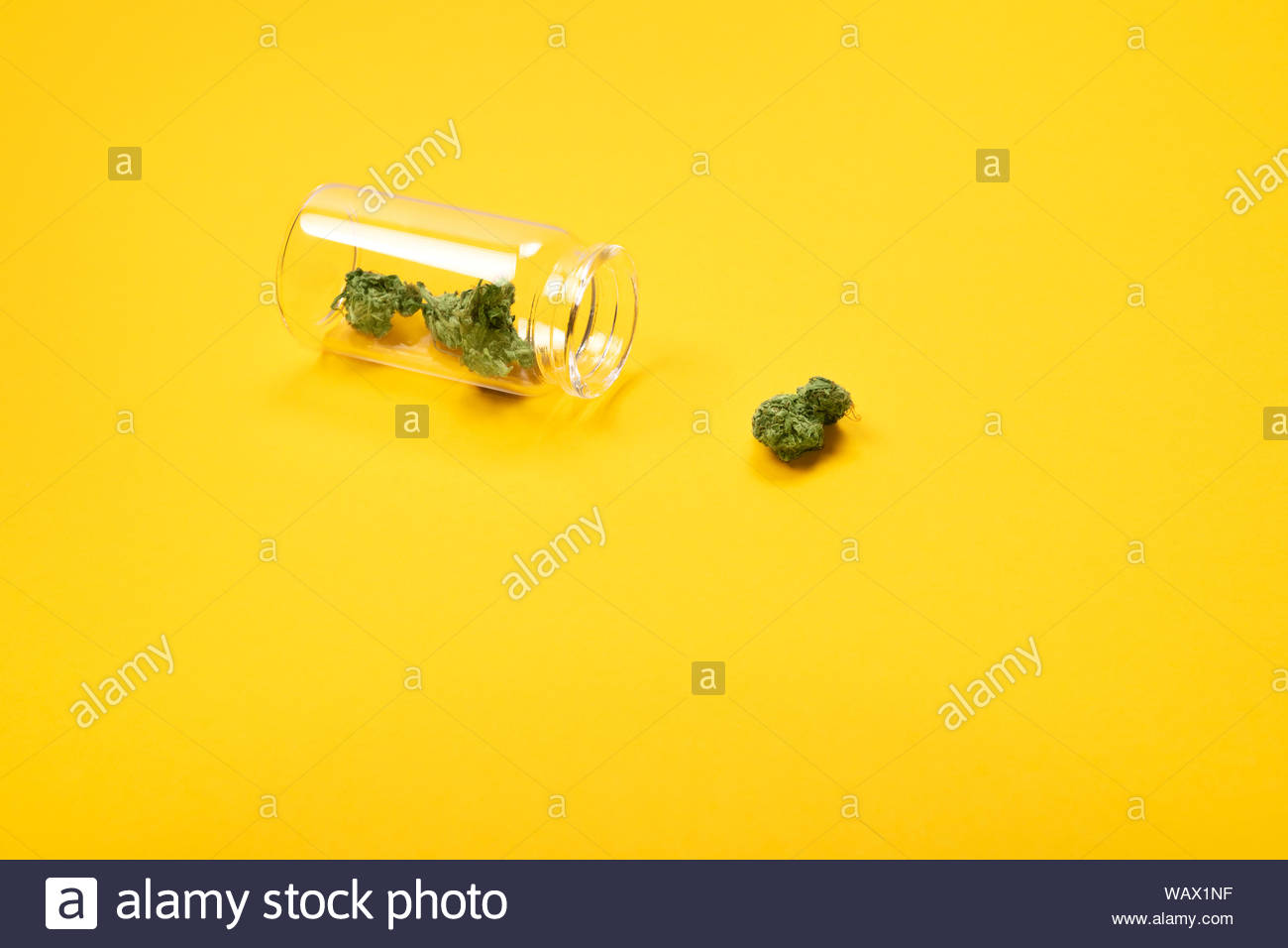 Download Dried Medical Marijuana Buds In A Small Open Glass Jar And Scattered Aside On Yellow Background Alternative Treatment Medical Cannabis Place For Tex Stock Photo Alamy PSD Mockup Templates
