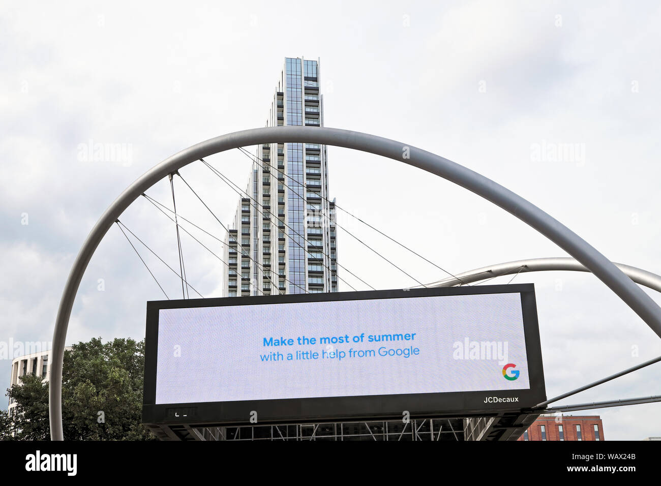 Electronic billboard message 'Make the most of summer with a little help from Google ' & grey sky at Old Street Roundabout in London Tech City UK Stock Photo