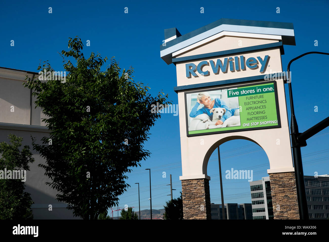 A logo sign outside of a RC Willey Home Furnishings retail store