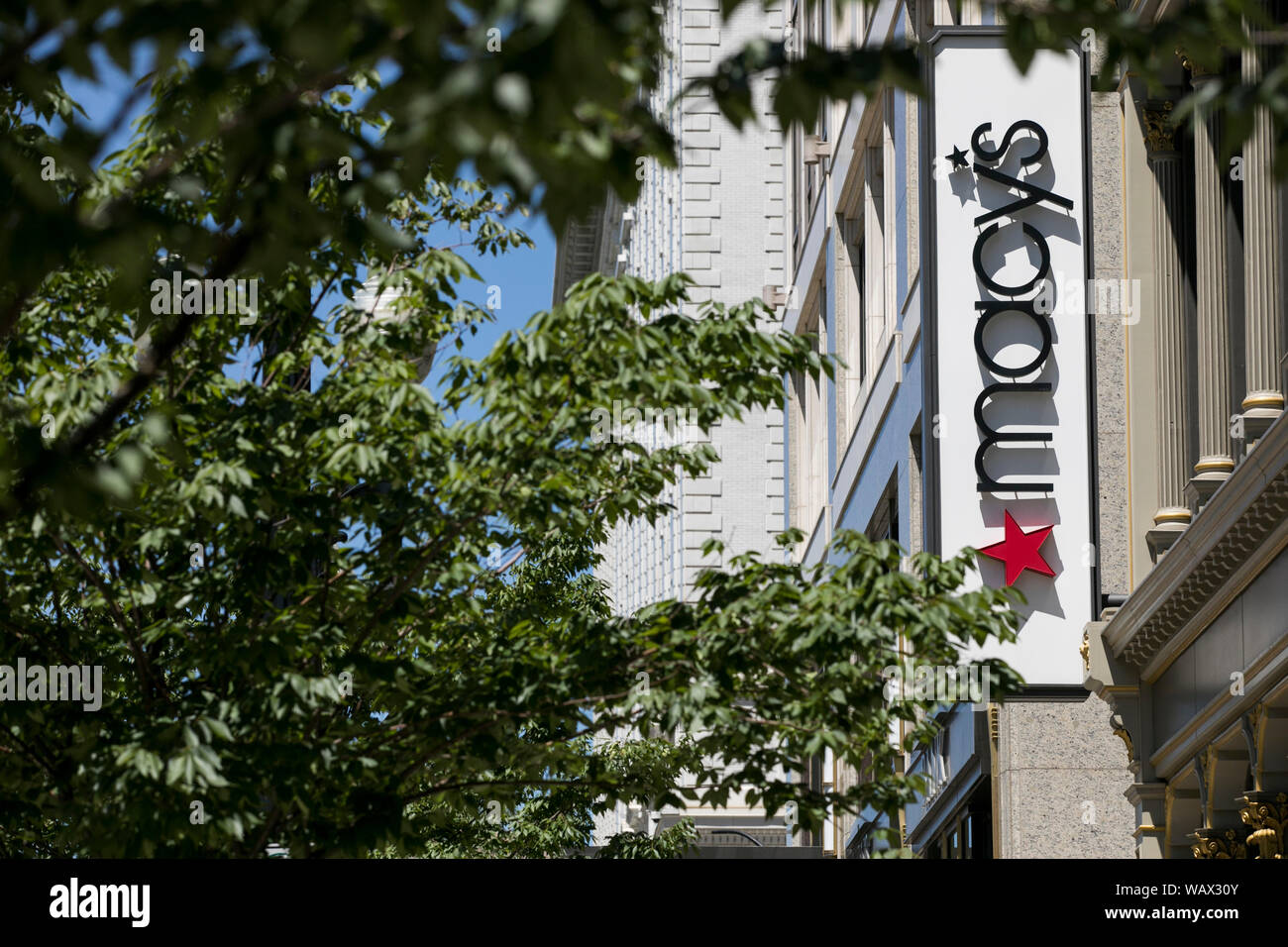 A logo sign outside of a Macy's retail store location in Salt Lake City