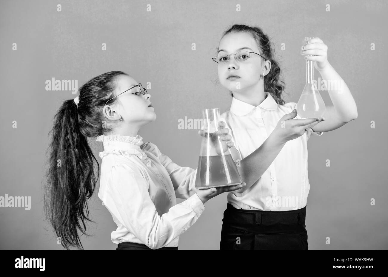 children study chemistry lab. back to school. biology education. little smart girls with testing flask. school kid scientist studying science. Bright minds at work. laboratory work. school work place. Stock Photo