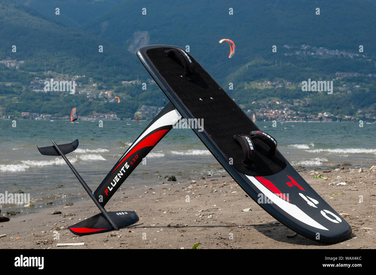 Lake Como, Italy - July 21, 2019. Windfoil gear on a beach near water.  Windsurf foiling is new style of windsurfing. Alp mountains and kite on  backgro Stock Photo - Alamy