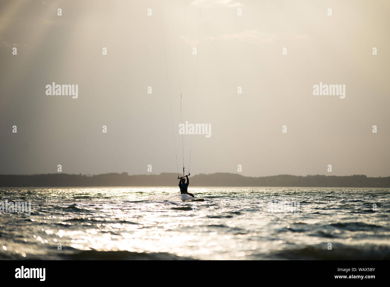 Silhouettes of kitesurfers on the Chiemsee Stock Photo