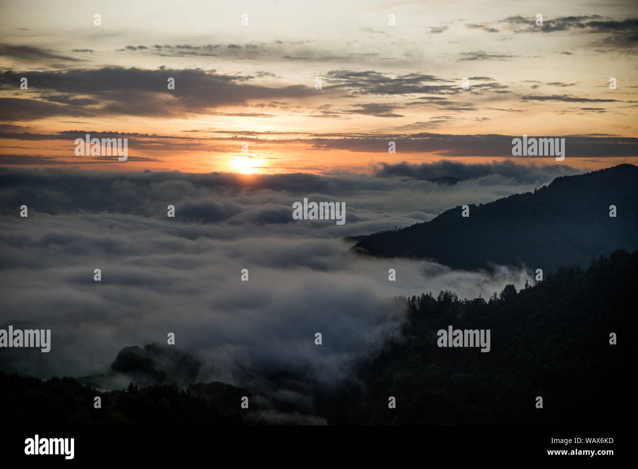 Sunrise in the mountains over the fog Stock Photo
