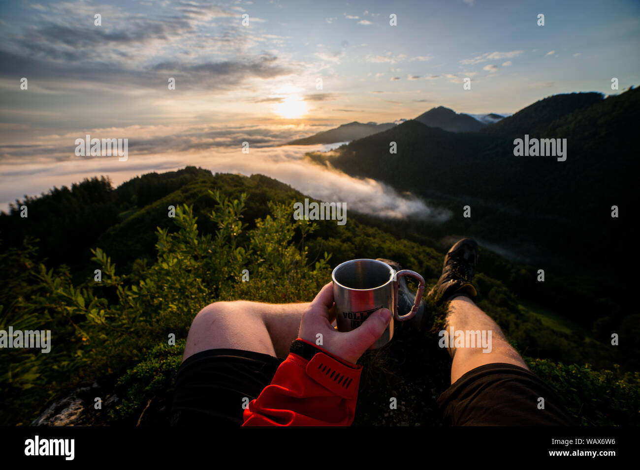 First person view of drink coffee in the mountains Stock Photo