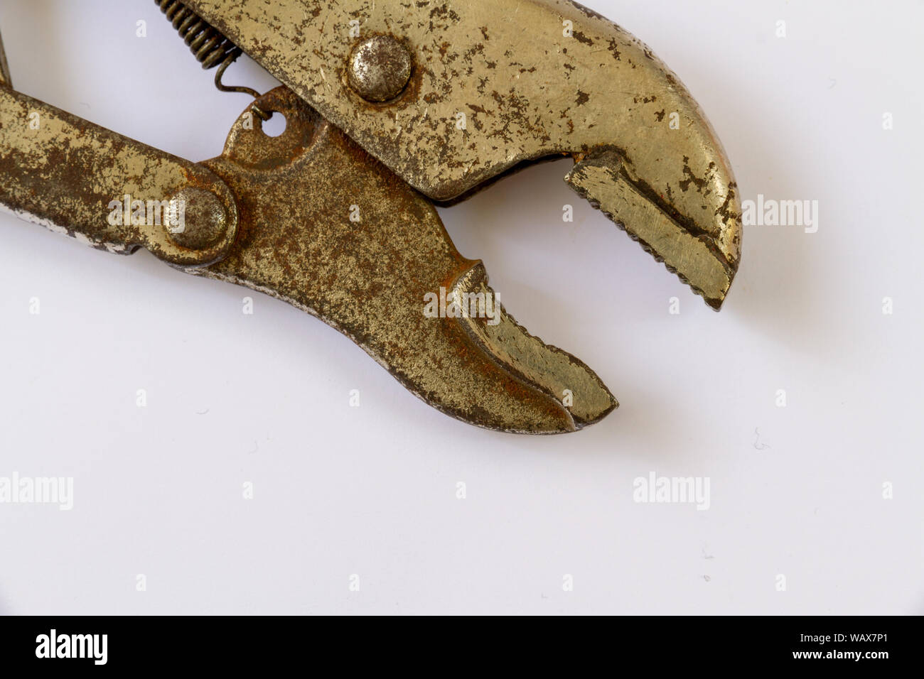 looking down on the jaws of a well worn mole grip or self locking wrench isolated on a white background Stock Photo