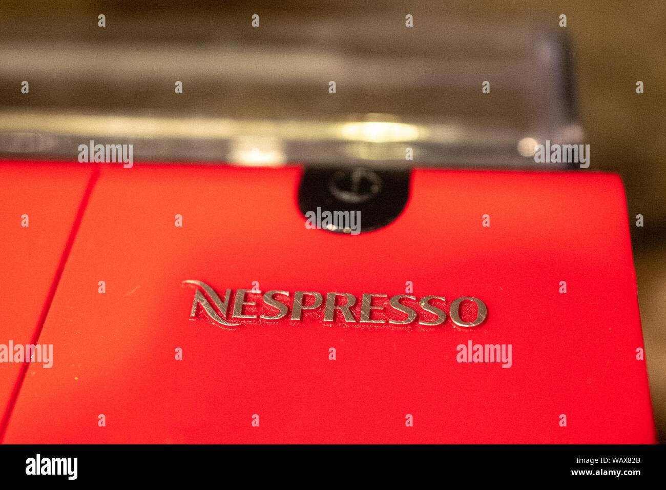 Close-up of logo for Nespresso, a brand of Nestle, on a red espresso maker in a domestic kitchen, August 21, 2019. () Stock Photo