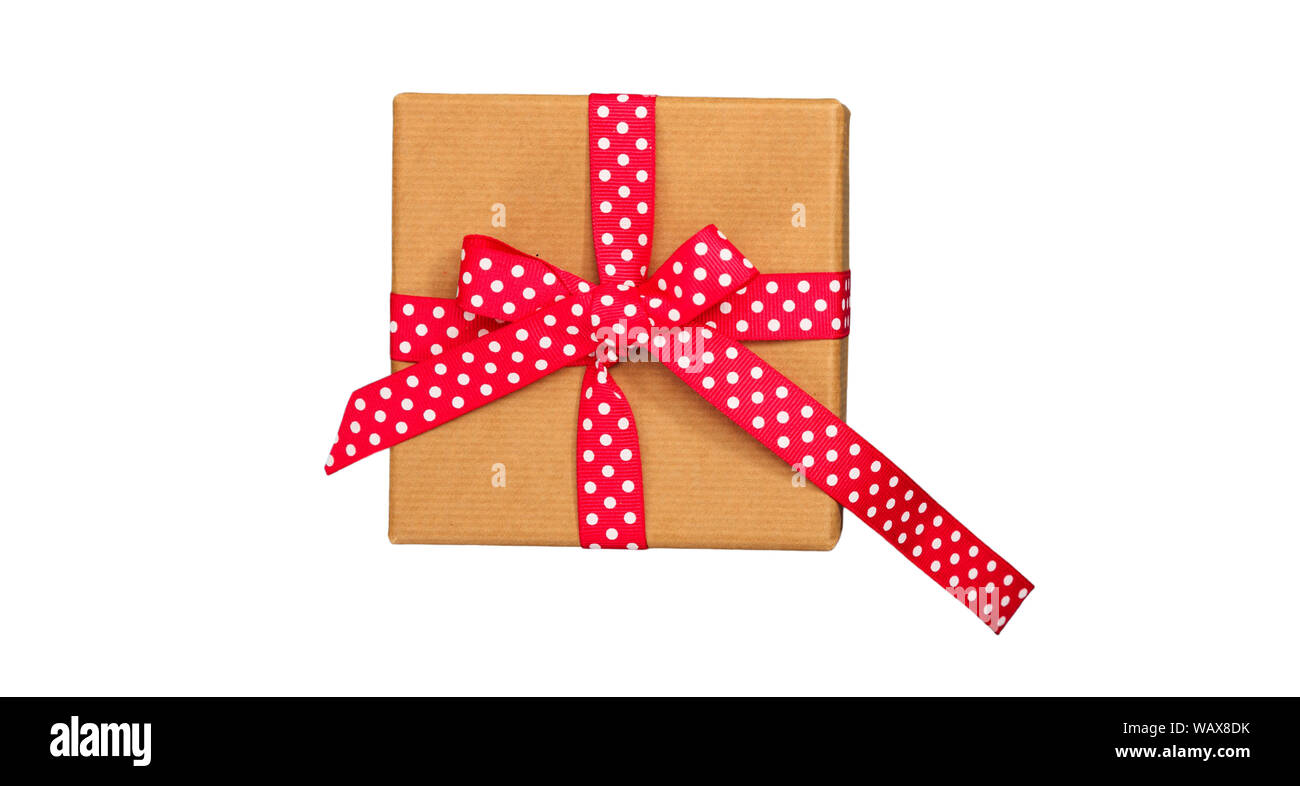 Three gifts in beige wrapping paper tied with brown ribbons on brown Stock  Photo - Alamy