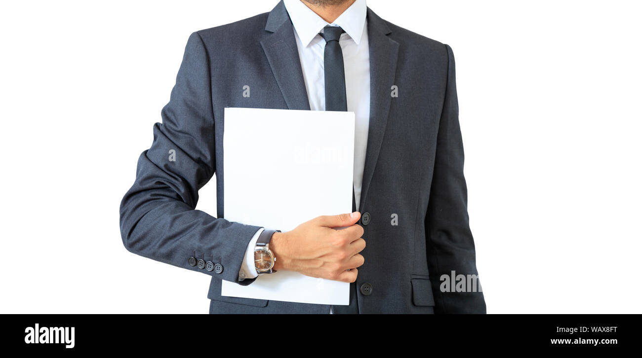 Young businessman in gray suit and tie holding documents isolated cutout, against white background. Stock Photo