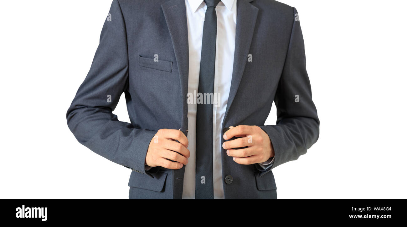 Young businessman buttoning his gray suit standing isolated cutout, against white background. Stock Photo