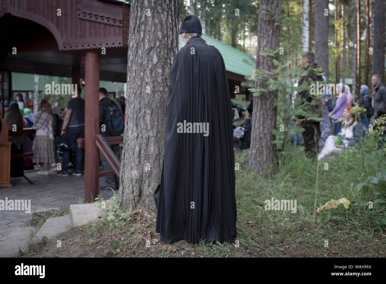 A monk of the monastery on behalf of the bearers of the Royal Passion in the Ganina Yama region in front of the pit prays where the Romanov family wer Stock Photo