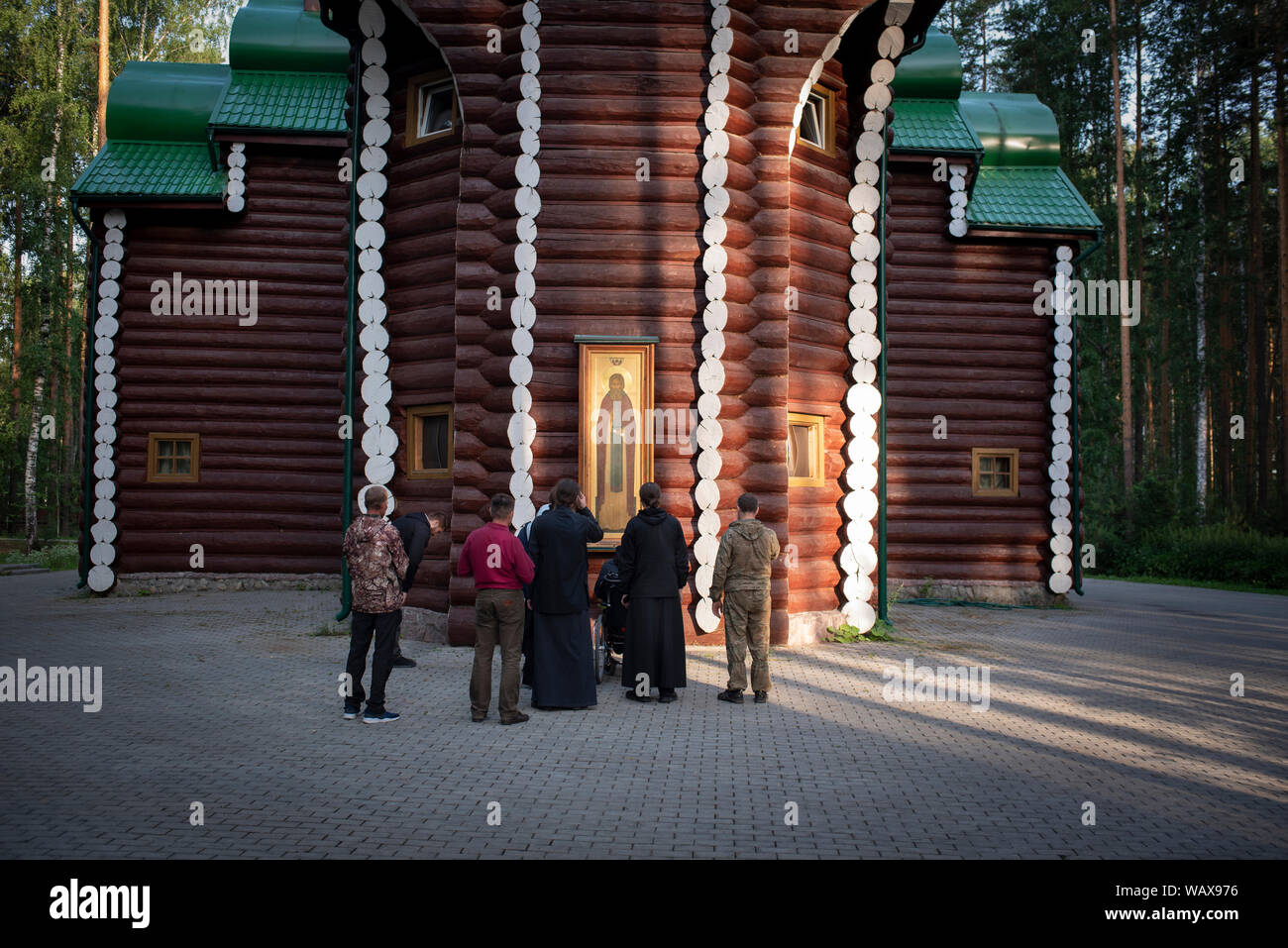 Small isolated groups come to pray in front of the representation of the icon of Rostov of Saint Sergei de Radonezh. Stock Photo