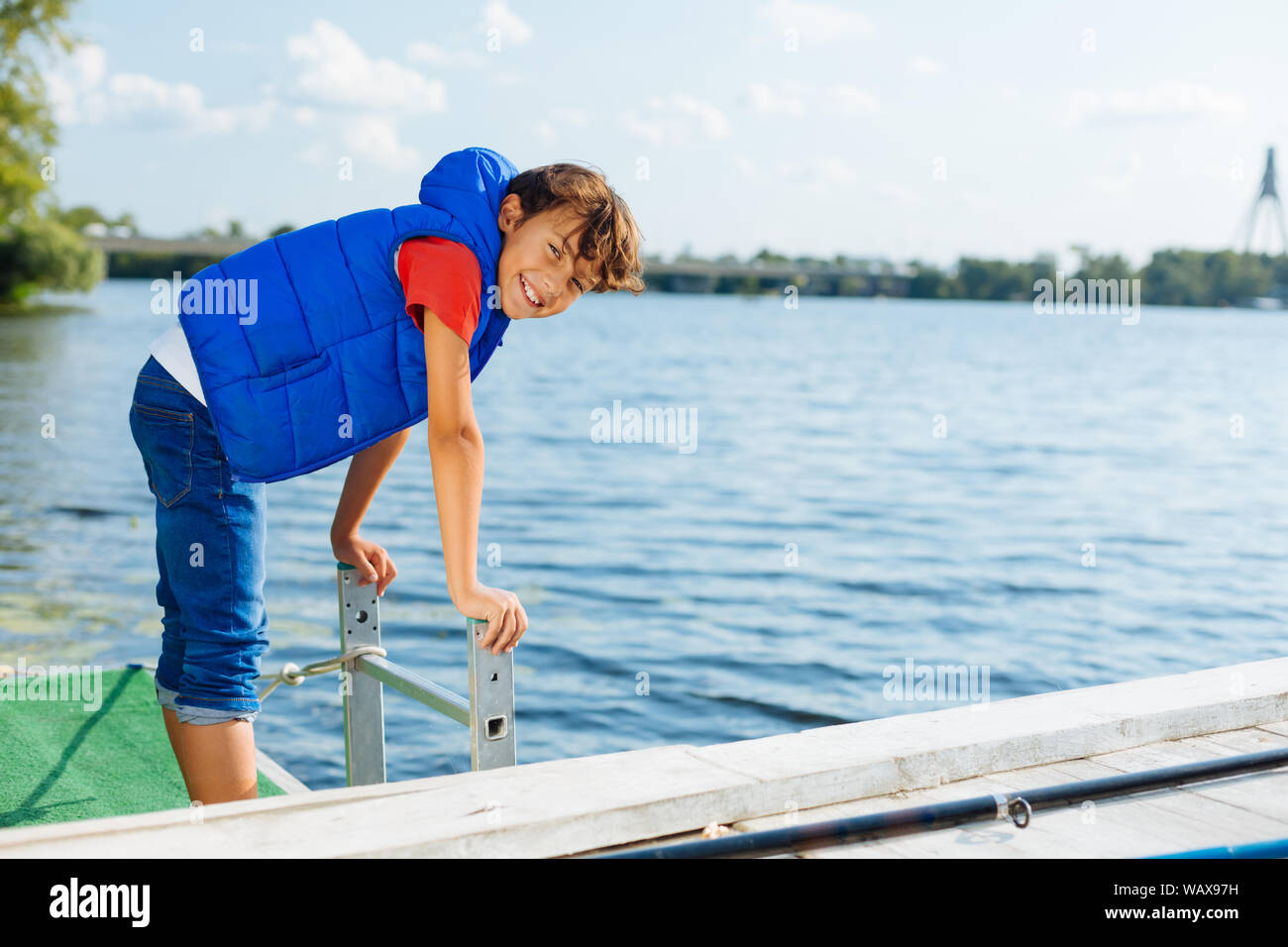 Schoolboy feeling happy while spending time near river Stock Photo Alamy