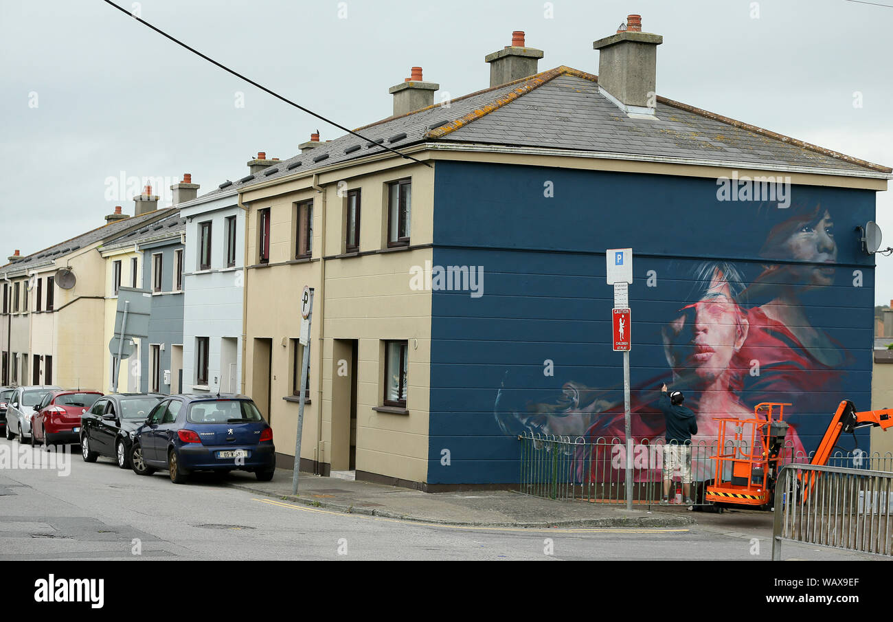 Artist Spear works on a mural titled 'Karelis' which forms part of the Waterford Walls graffiti and street art festival taking place between 22 and 25 August in Waterford city, Ireland. Stock Photo