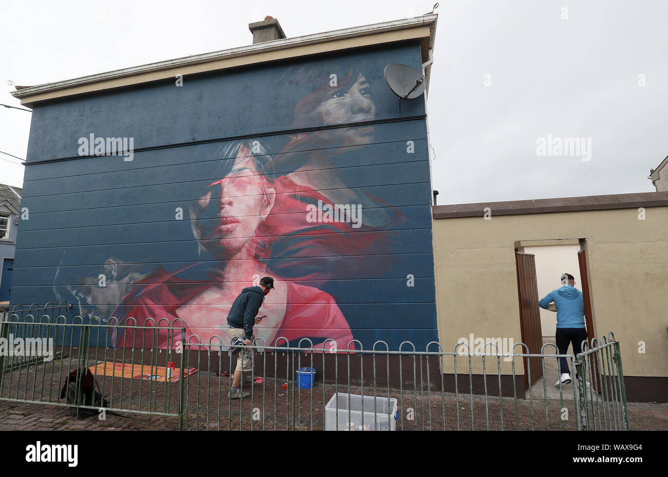 Artist Spear works on a mural titled 'Karelis' which forms part of the Waterford Walls graffiti and street art festival taking place between 22 and 25 August in Waterford city, Ireland. Stock Photo
