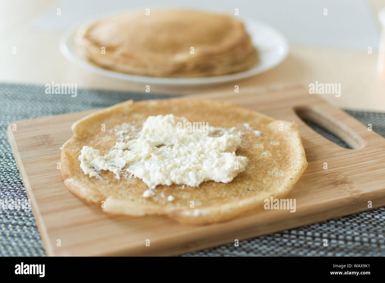 Traditional russian pancakes staffed with cottage cheese Thin homemade pancakes with crispy crust. Maslenitsa holiday. Stock Photo