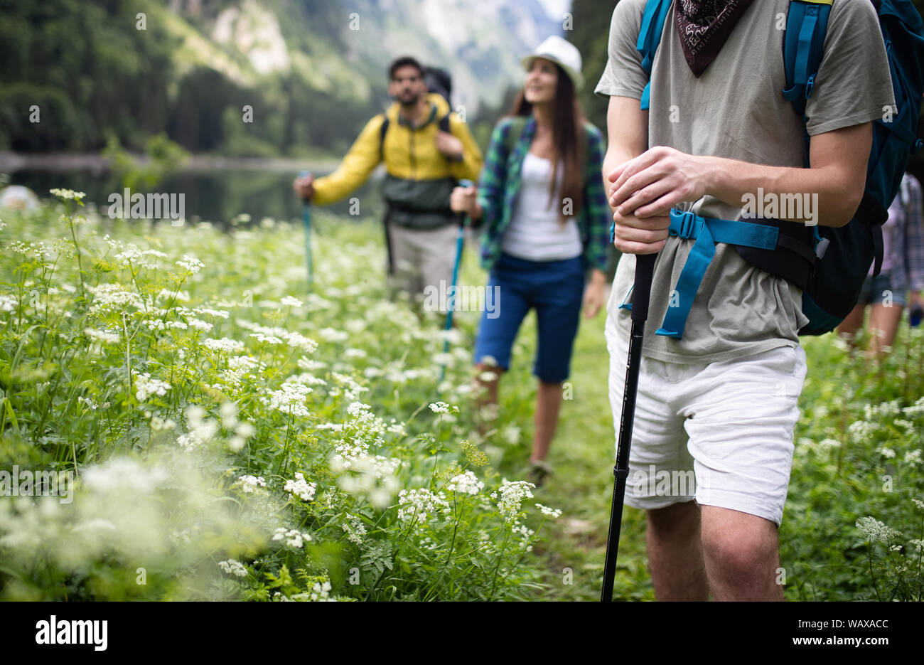 Group of happy friends with backpacks hiking together Stock Photo - Alamy