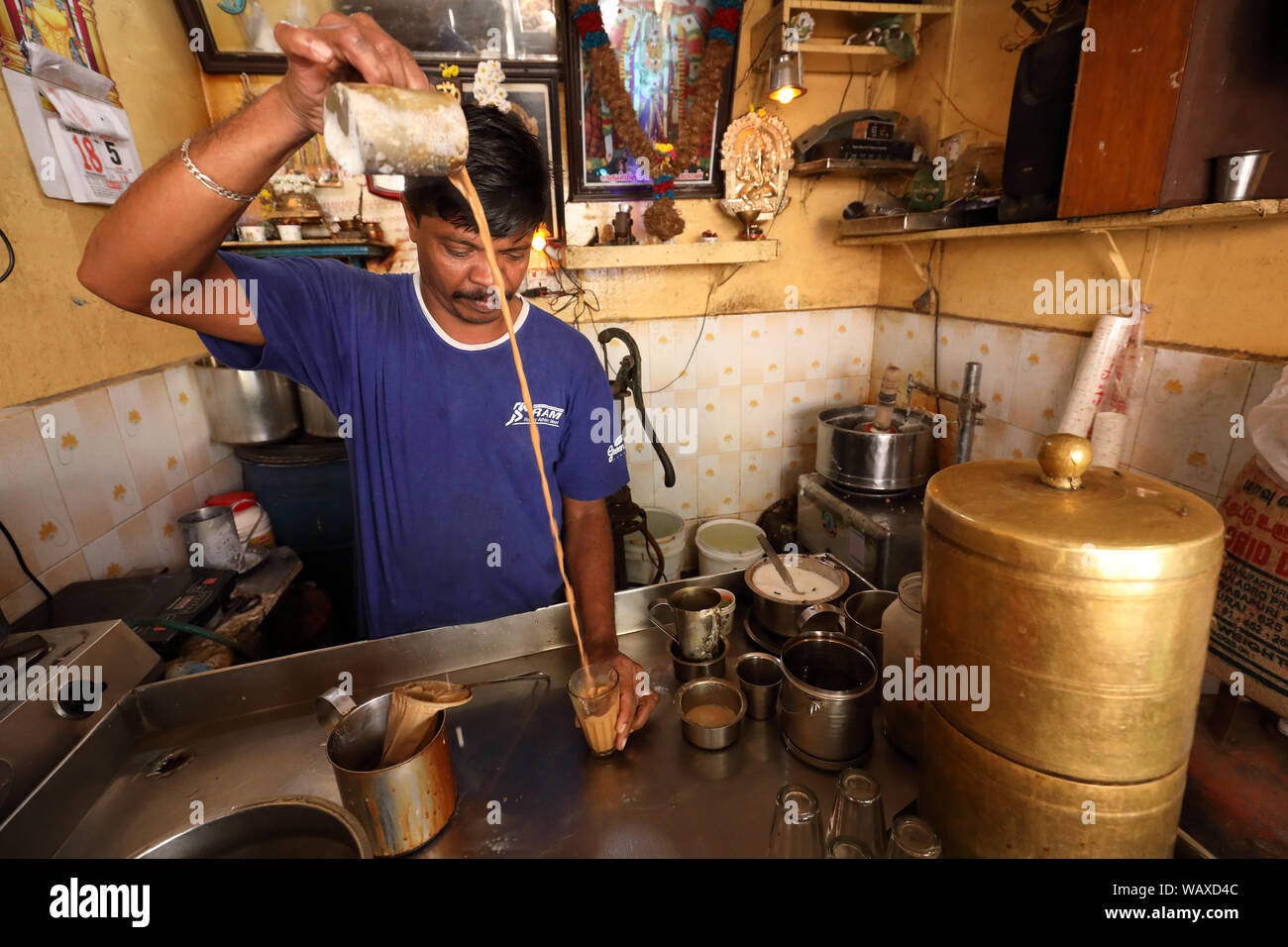 Tea wallah preparing tea in a small traditional stall in Madurai, India. Stock Photo