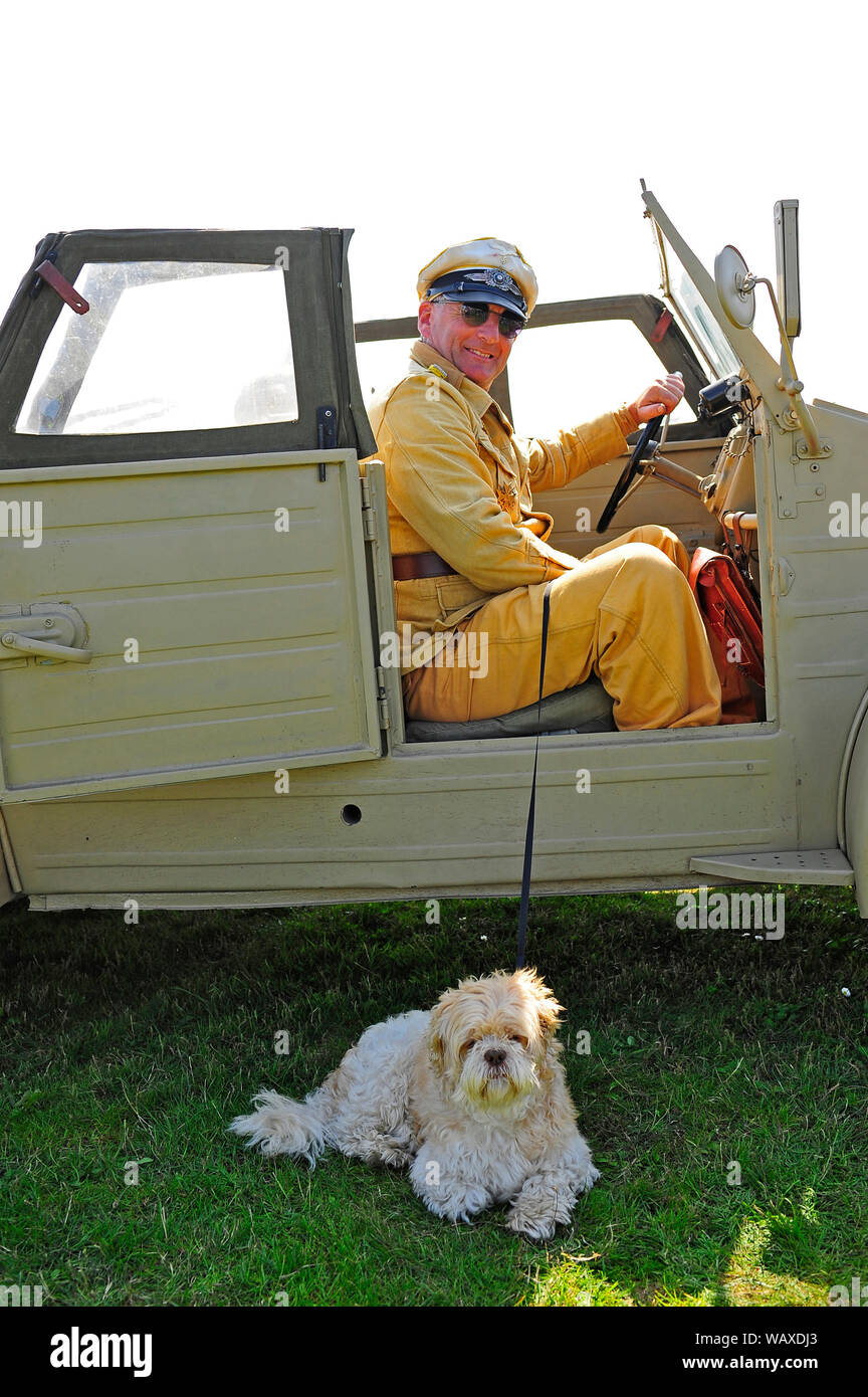 1940s wartime festival weekend  at Lytham,Lancashire,UK. Man and dog in a Kubel personnel carrier designed by Porsche and built by Volkswagan Stock Photo