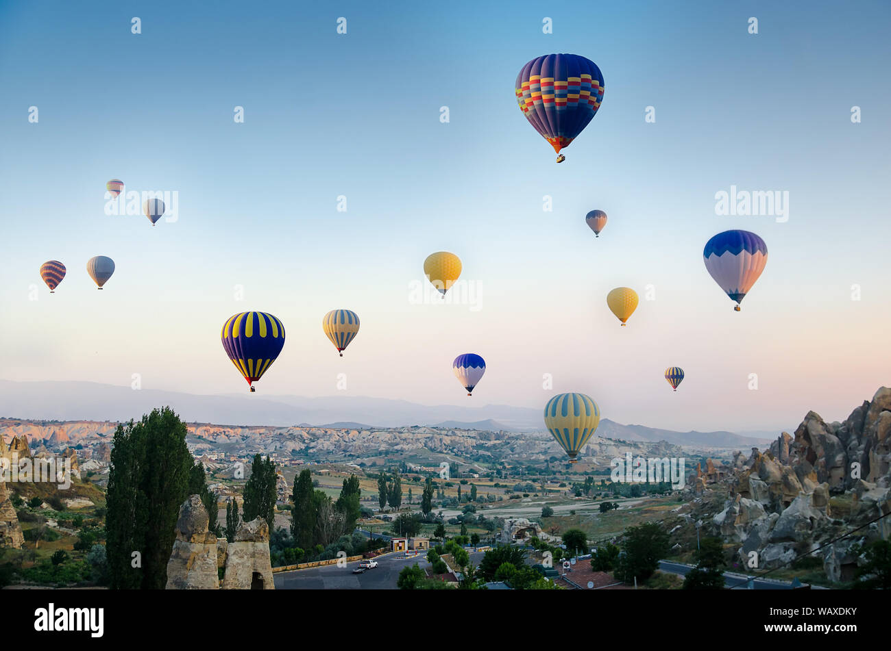 Hot air balloon flying over rock landscape at Cappadocia Turkey Stock ...