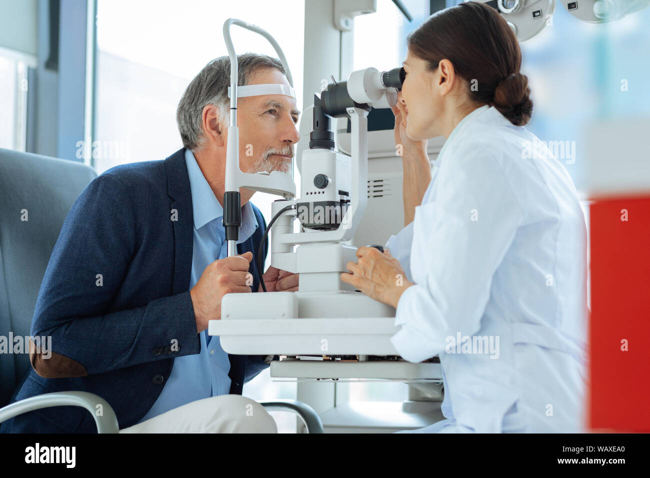 Professional eye doctor sitting opposite her patient Stock Photo Alamy