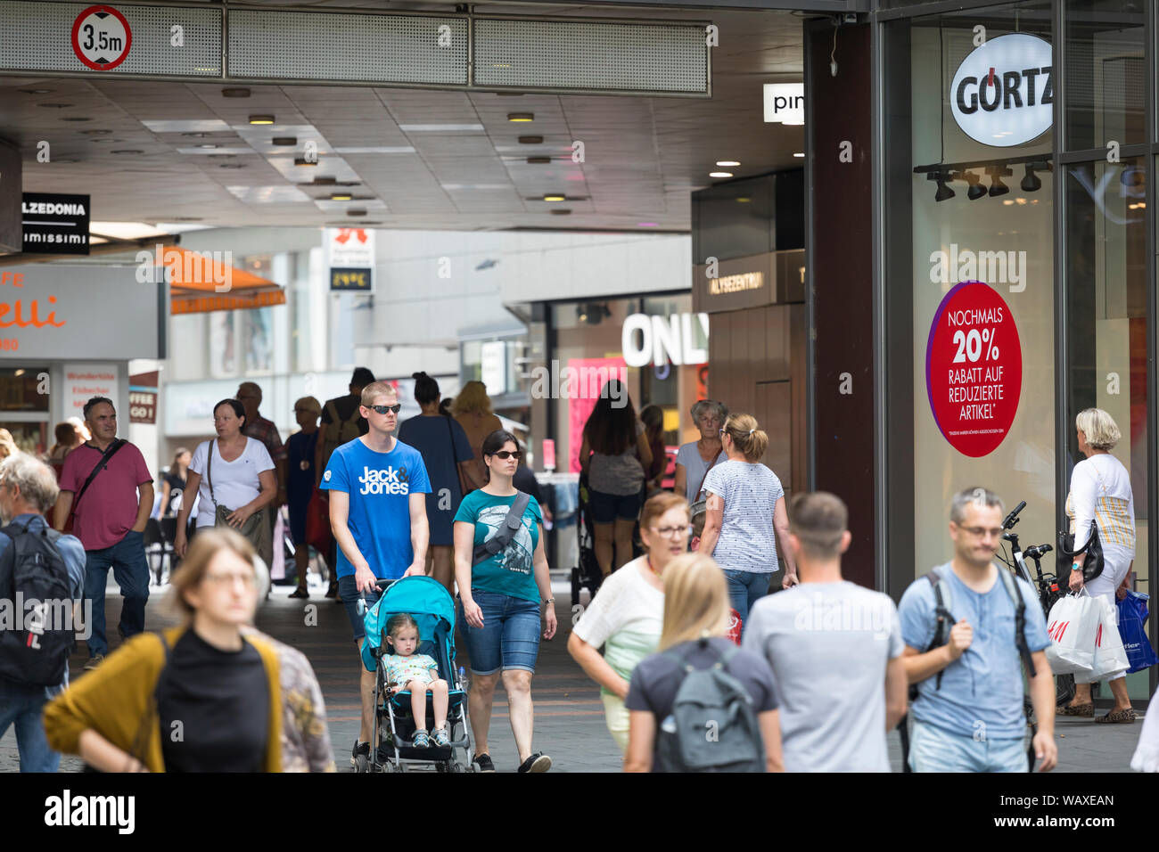 People walking at a modern  inner city shopping street in Mainz, Germany Stock Photo