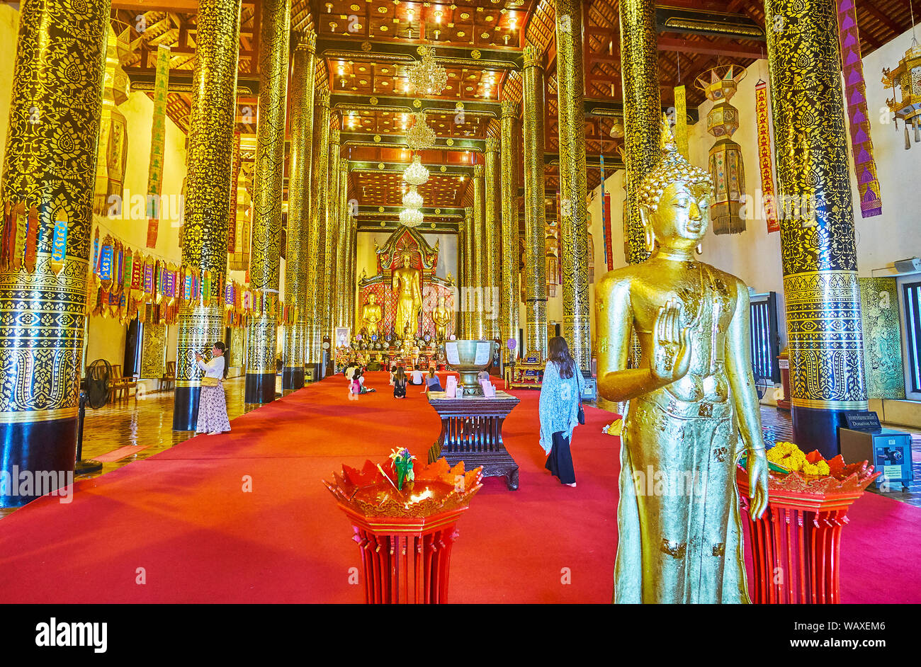 CHIANG MAI, THAILAND - MAY 2, 2019: Splendid interior of Phra Viharn Luang of Wat Chedi Luang complex with golden Buddha images and tall columns, cove Stock Photo