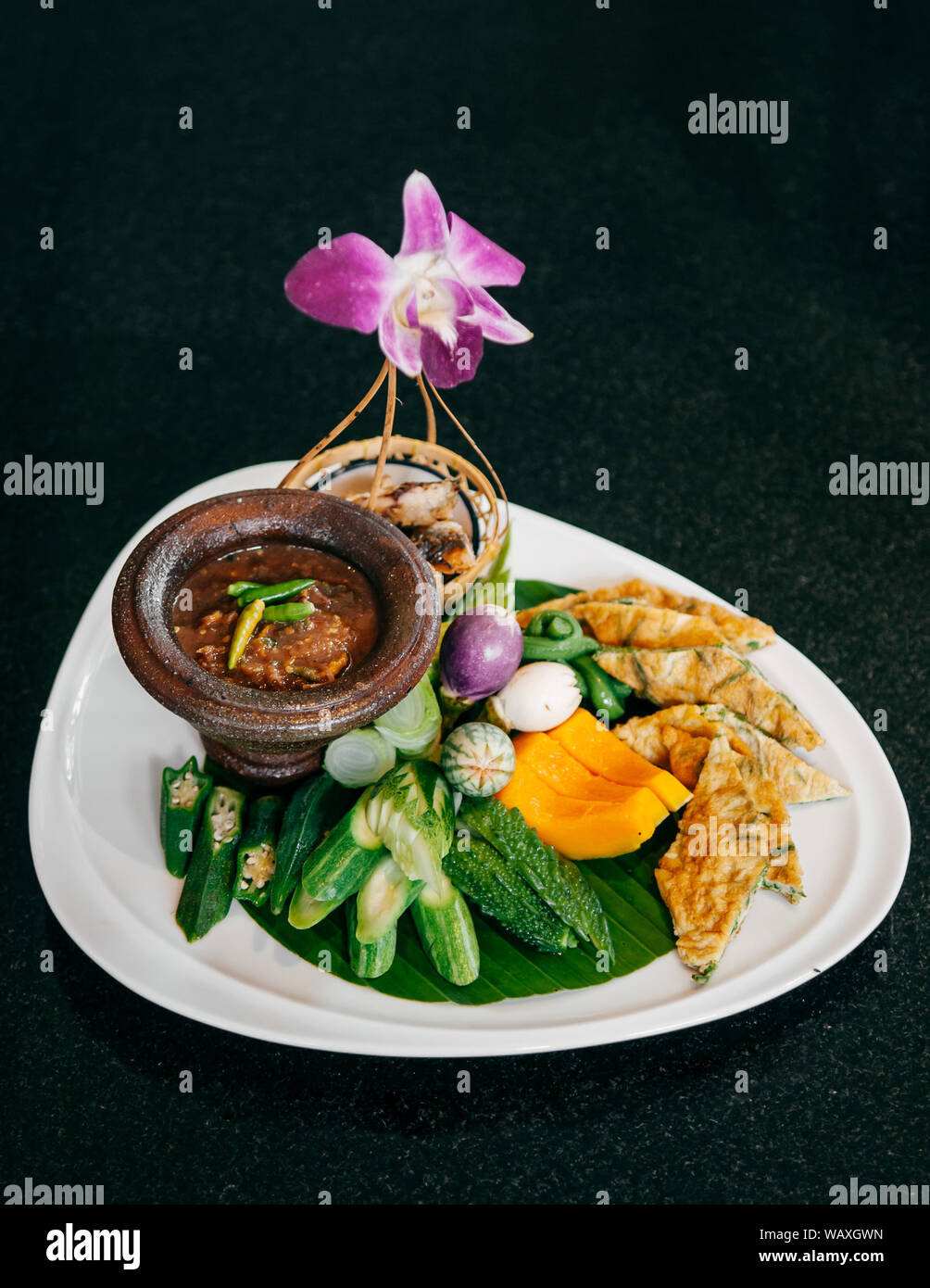Thai spicy shrimp paste chili dip in mortar cup with assorted