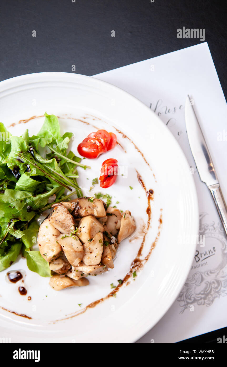 Grilled chicken garlic with green rocket salad and sweet balsamic dressing and tomato. Stock Photo