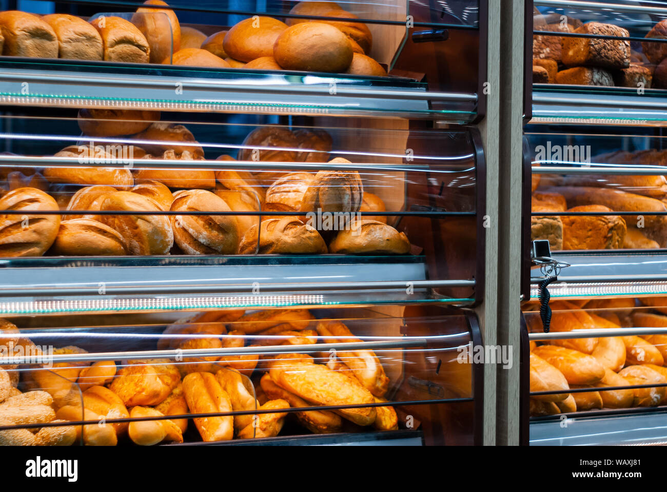 background - shelves in a grocery store with fresh bread of different varieties Stock Photo