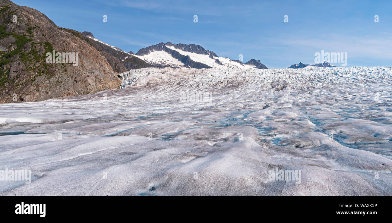 aerial view of mendenhall glacier in alaska from a low flying helicopter with blue sky in the background Stock Photo