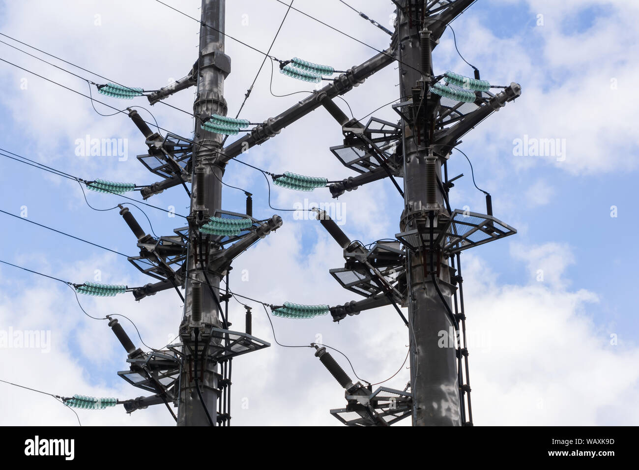 Dual R60 Pylon fragment of a massive dual power line pylon with green insulators and ...