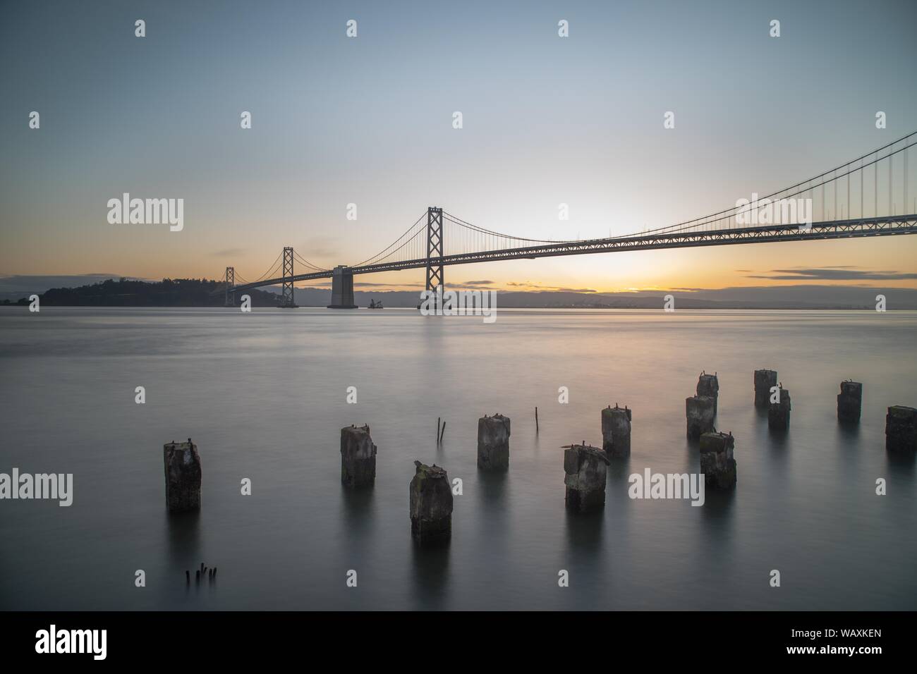 wide-shot-of-bay-bridge-on-the-body-of-water-during-sunrise-in-san