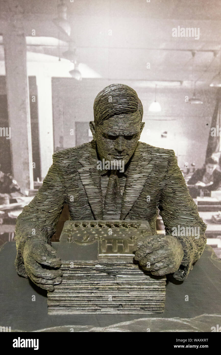 A sculpture of Alan Turing operating a German Enigma machine at Bletchley Park, England Stock Photo