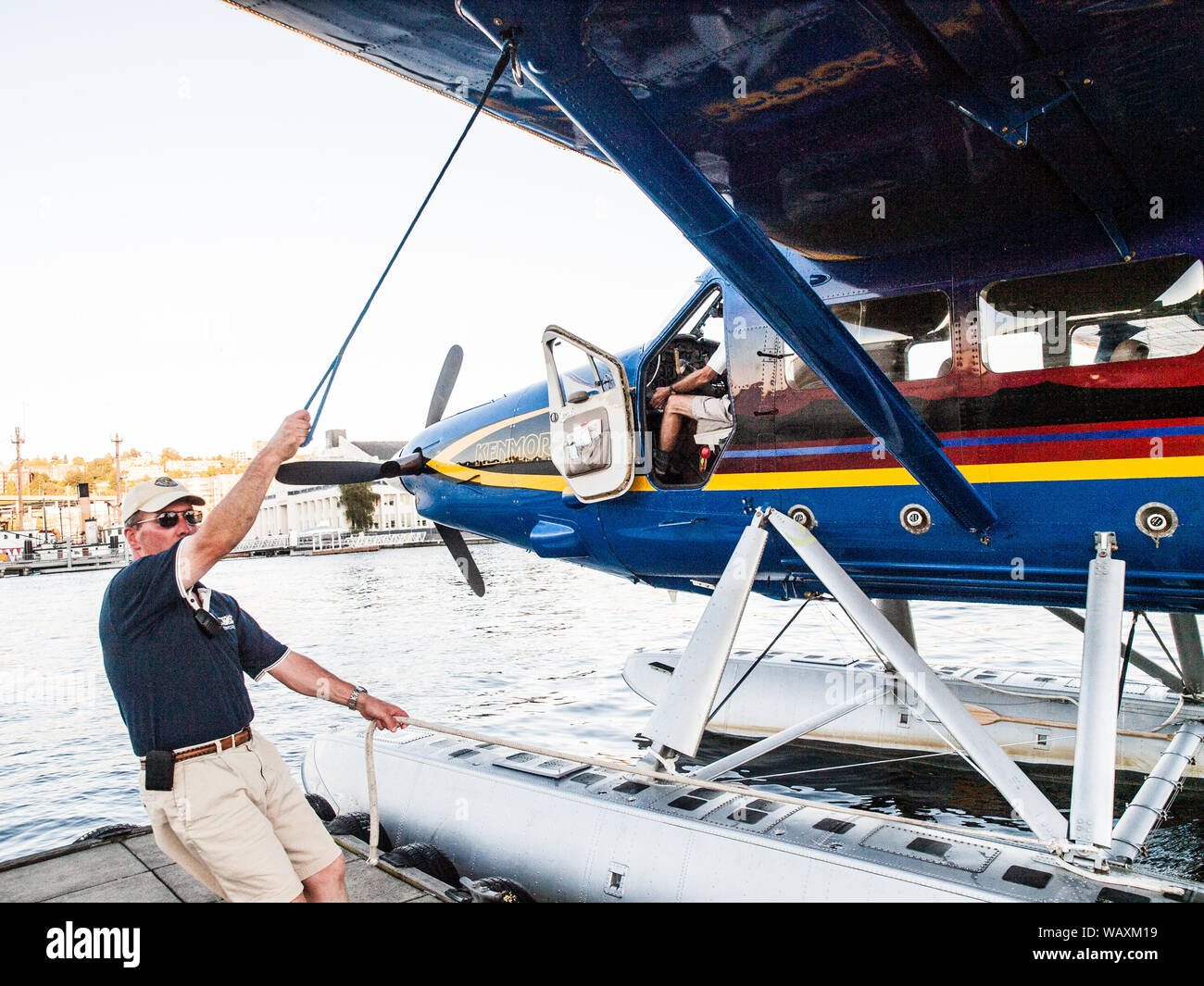Floatplane crew member tying down on dock Stock Photo Alamy