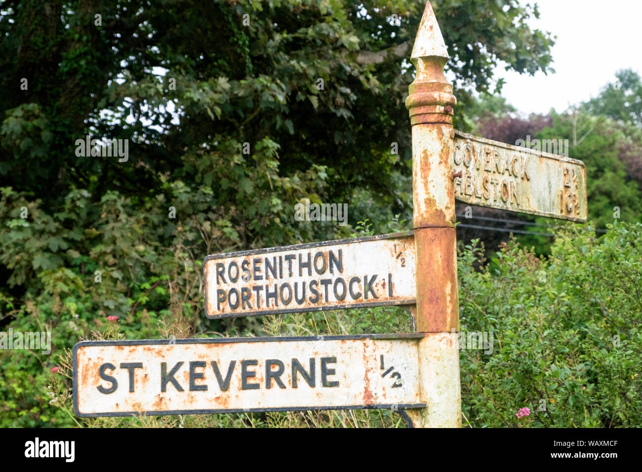 Old rusty sign post to St Keverne on the Lizard peninsula, near Roskillys Farm, Cornwall,UK. Stock Photo