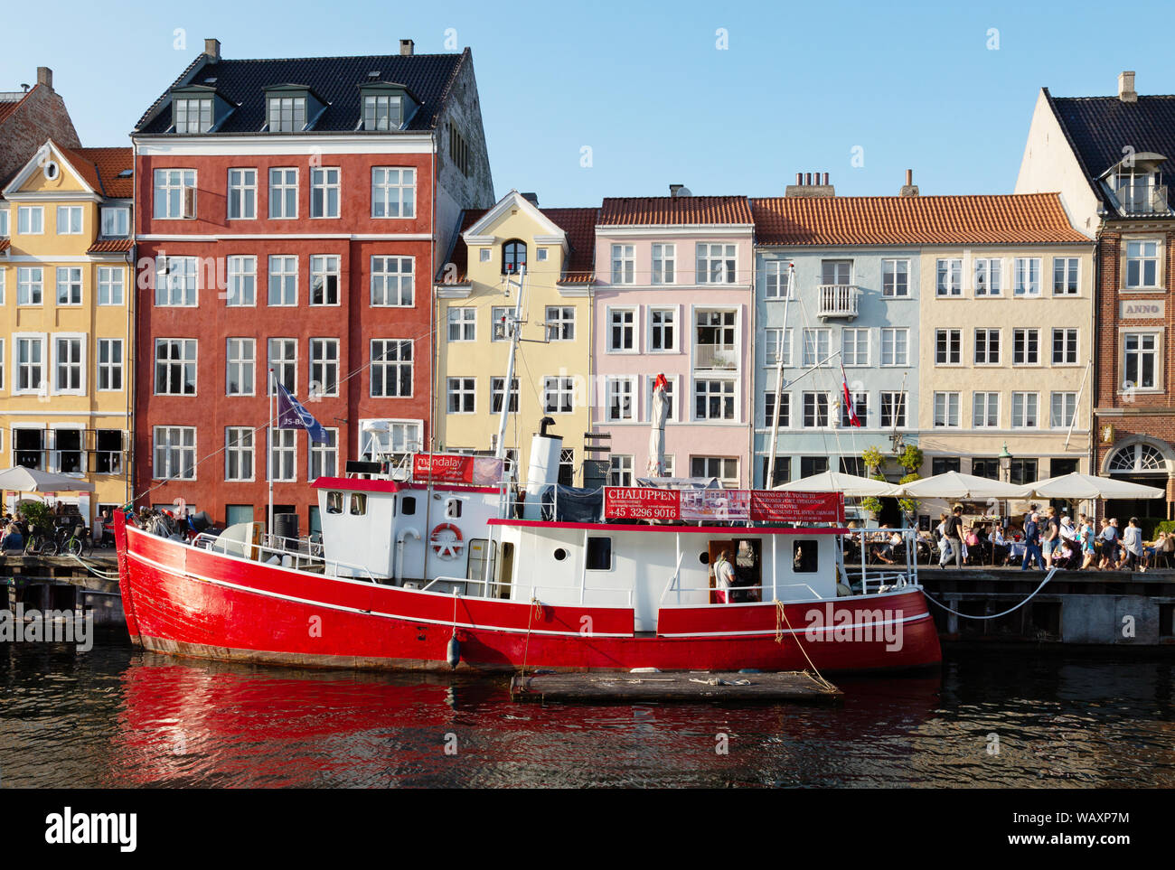 Nyhavn Copenhagen Denmark - colourful buildings and boat in summer sunshine in August, Nyhavn waterfront, Copenhagen Denmark Scandinavia Europe Stock Photo