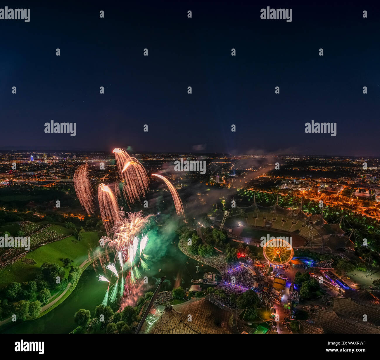 Fireworks captured from a high perspektiv with a big city wide view over Munich. Stock Photo