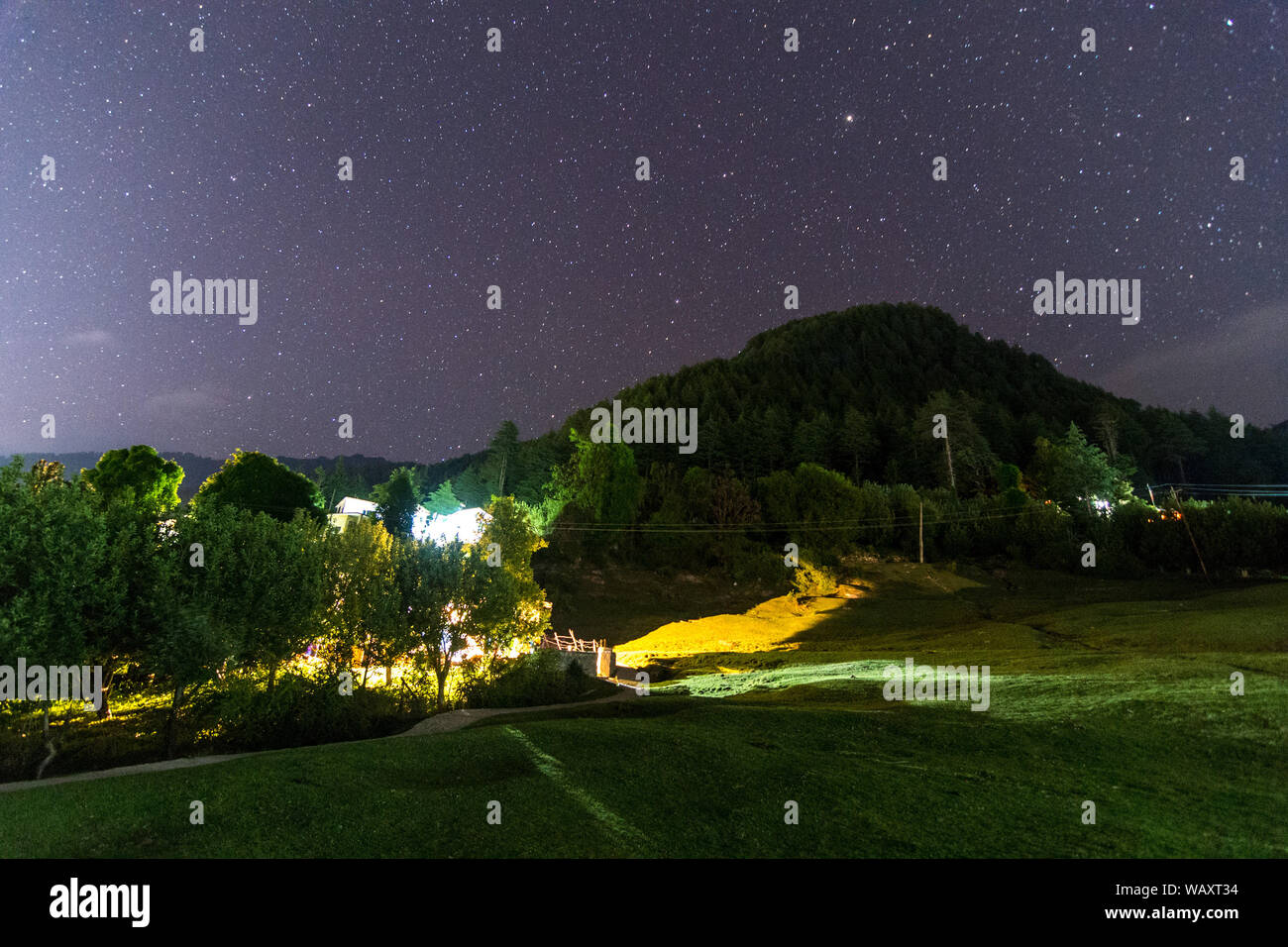 night landscape, village house under the stars at night in himalayas ...