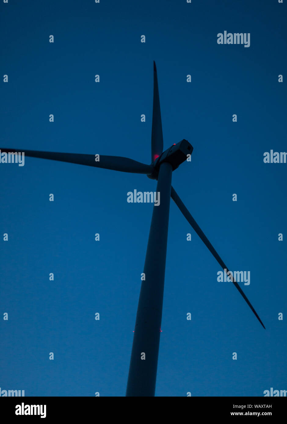 Wind power wind turbine at night with signal lights germany sustainability energy turnaround Stock Photo