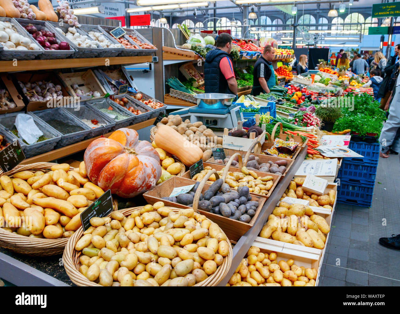 Stand with a colorful assortment of potatoes, pumpkins, fruits and vegetables at the Wazemmes Market. It is one of Lilles largest markets. Stock Photo