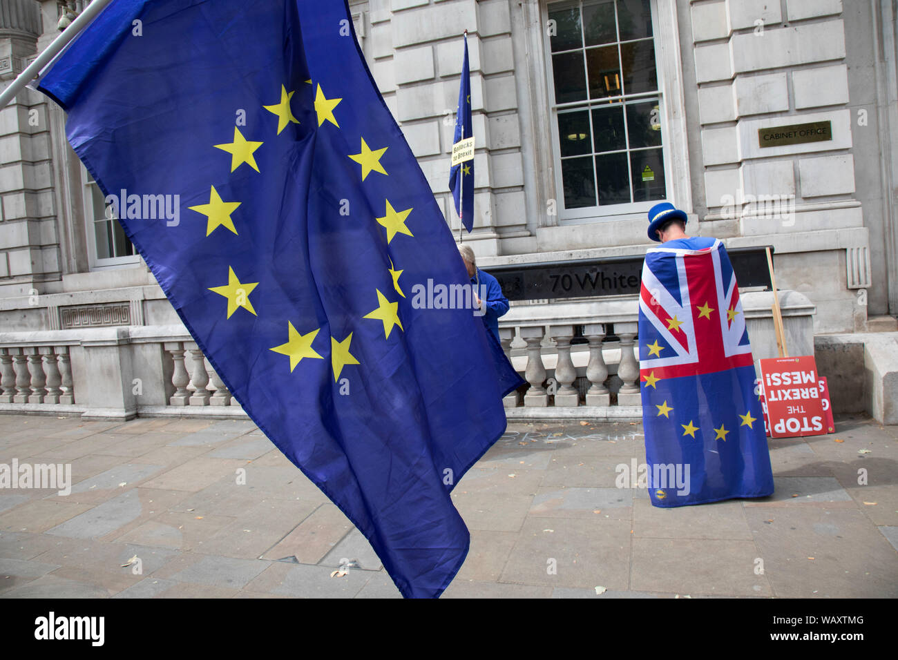 Anti Brexit protesters waving European Union flags outside the Cabinet Office in Westminster as inside the Tory Cabinet meets to discuss Brexit on 16th August 2019 in London, England, United Kingdom. Stock Photo
