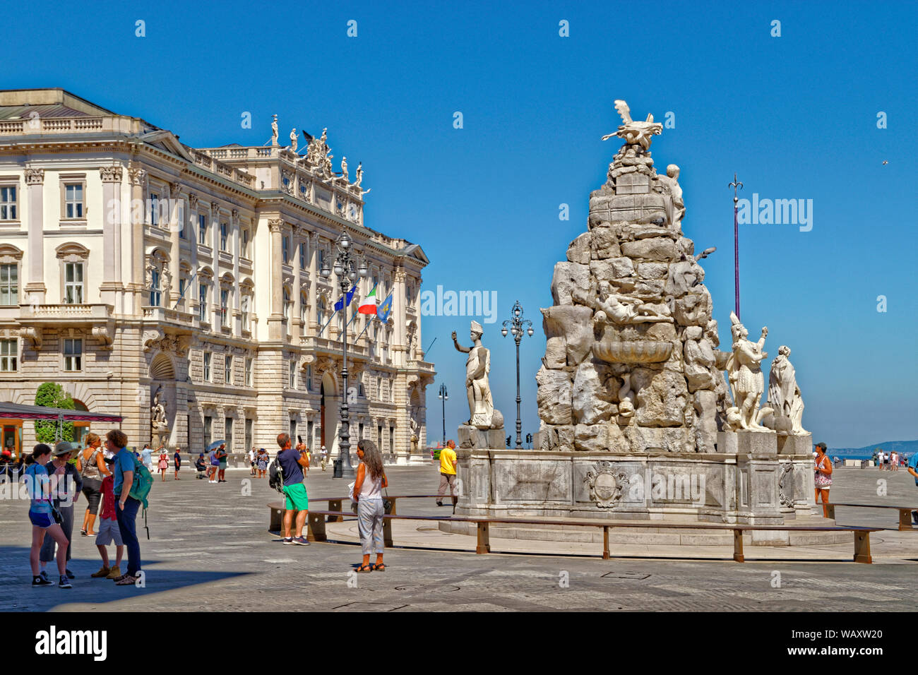 Piazza Unità d'Italia or Unity of Italy Square featuring the Fontana dei Quattro Continenti,or the Fountain of Four Continents in Trieste, Italy. Stock Photo