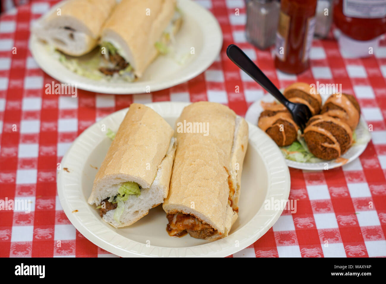 A Sausage Po' Boy Sandwich with Boudin Balls from New Orleans. Stock Photo