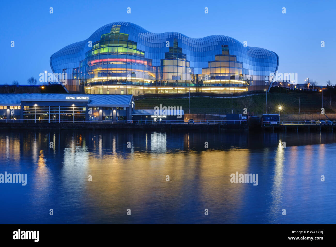 Evening blue hour view across the river Tyne of the coloured lights of the Sage concert hall and cultural venue in Gateshead . Stock Photo