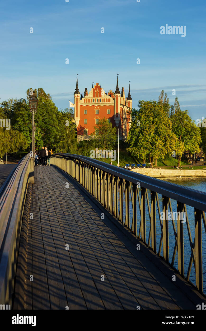 Skeppsholmen island bridge (Skeppsholmsbron) and Bergrummet Tido collection of toys and Comics museum building surrounded by green. Stockholm, Sweden. Stock Photo