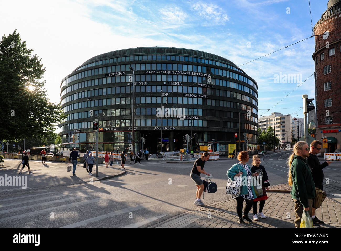 Ympyrätalo - a circle-shaped office building backlit by evening sun - in Hakaniemi district of Helsinki, Finland Stock Photo