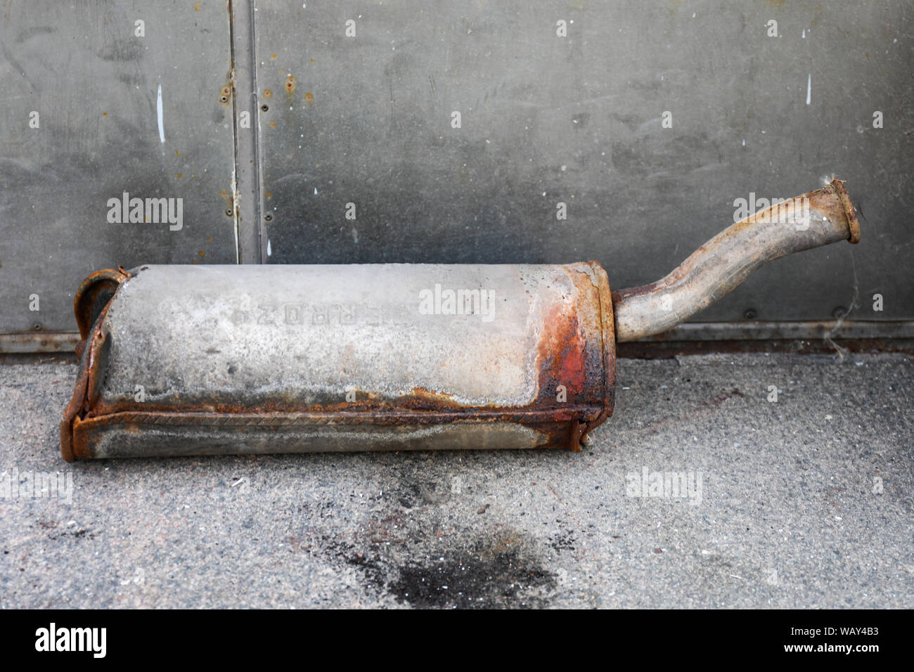 Rusty silencer of an exhaust pipe lying on sidewalk Stock Photo Alamy