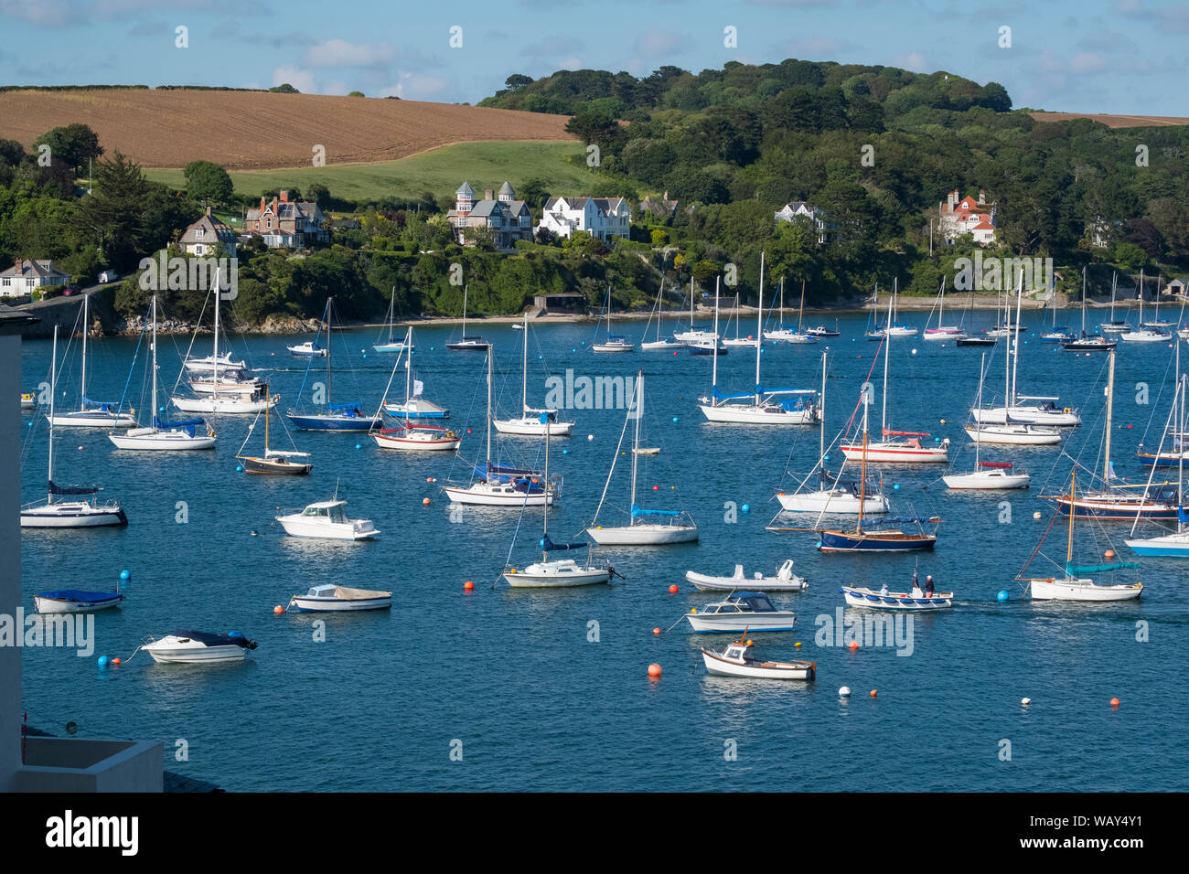 Boats moored at Falmouth harbour looking towards St Mawes, Cornwall, England, UK Stock Photo